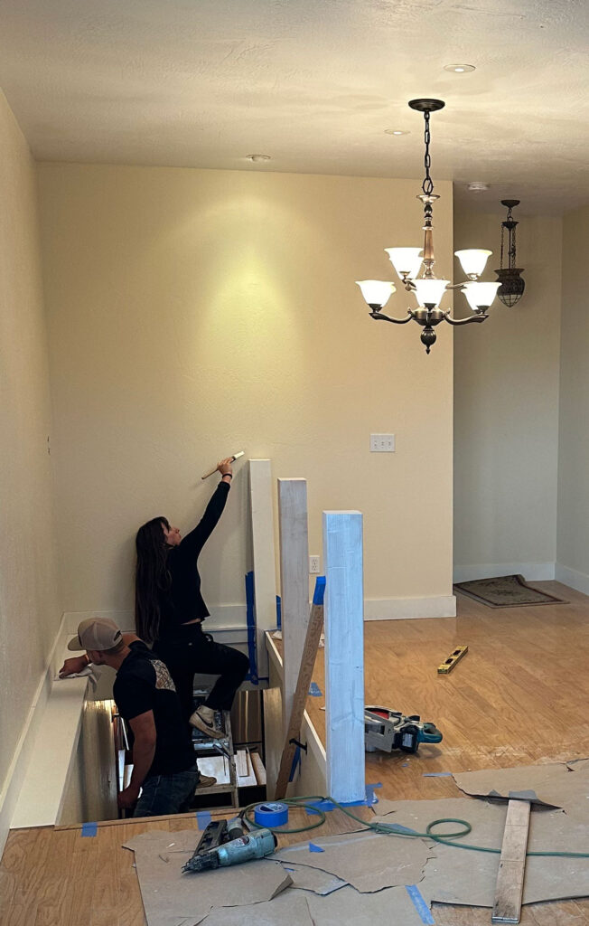 two people working on renovation project with new stairway